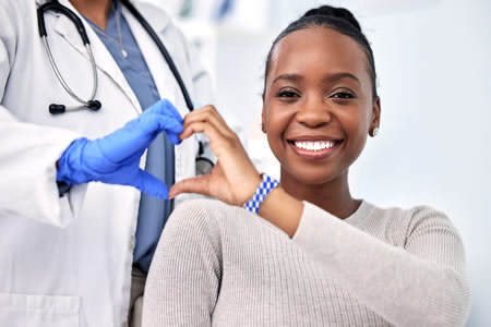 patient and doctor making a hand heart